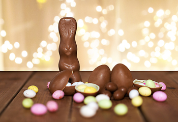 Image showing chocolate eggs, easter bunny and candies on wood