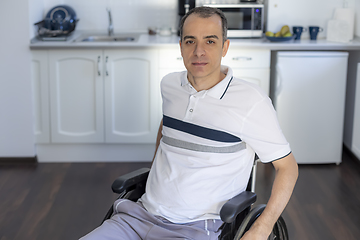 Image showing Smiling Young Handicapped Man Sitting On Wheelchair In Kitchen