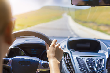 Image showing Girl hands on the steering wheel of a car while driving