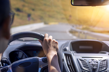 Image showing Girl hands on the steering wheel of a car while driving