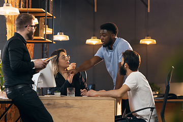 Image showing Colleagues working together in modern office using devices and gadgets during creative meeting