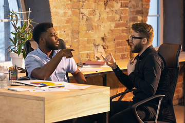 Image showing Colleagues working together in modern office using devices and gadgets during creative meeting