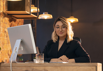 Image showing Businesswoman, manager working in modern office using devices and gadgets