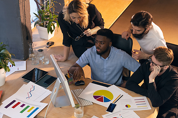 Image showing Colleagues working together in modern office using devices and gadgets during creative meeting