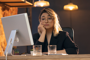 Image showing Businesswoman, manager working in modern office using devices and gadgets