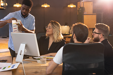 Image showing Colleagues working together in modern office using devices and gadgets during creative meeting