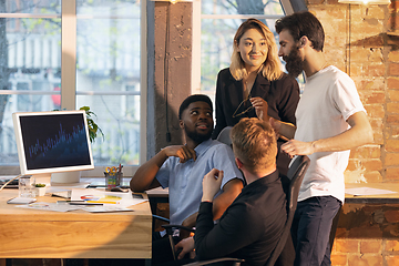 Image showing Colleagues working together in modern office using devices and gadgets during creative meeting