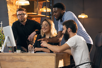 Image showing Colleagues working together in modern office using devices and gadgets during creative meeting