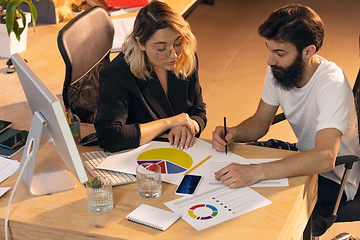 Image showing Colleagues working together in modern office using devices and gadgets during creative meeting