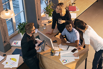 Image showing Colleagues working together in modern office using devices and gadgets during creative meeting