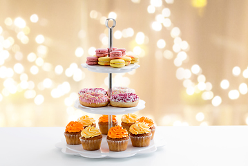 Image showing glazed donuts, cupcakes and macarons on stand