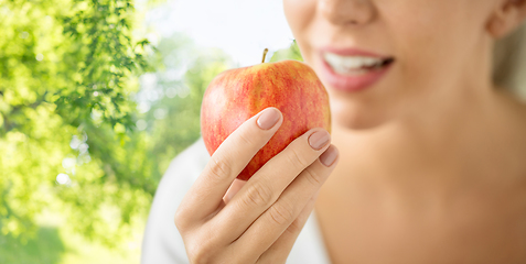 Image showing close up of woman holding ripe red apple