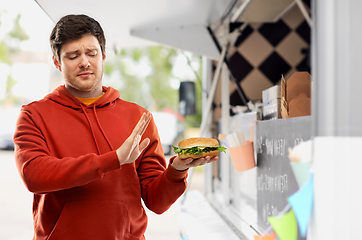 Image showing young man refusing from hamburger at food truck