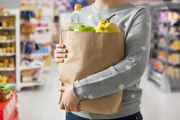 Image showing close up of woman with paper bag full of food