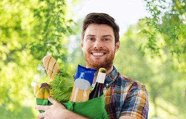 Image showing smiling young man with food in bag