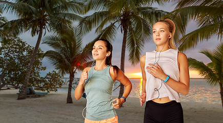 Image showing women or female friends with earphones running