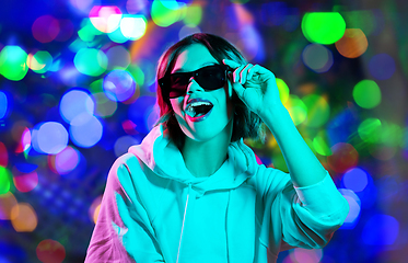 Image showing woman in hoodie with sunglasses over night lights