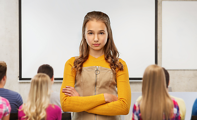 Image showing serious student girl with crossed arms at school
