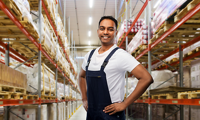 Image showing happy smiling indian worker or loader at warehouse