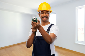 Image showing happy indian builder in helmet with electric drill