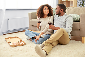 Image showing happy couple with wine and takeaway pizza at home