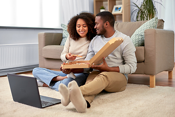 Image showing happy african american couple eating pizza at home