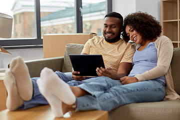 Image showing happy couple with tablet pc computer at new home