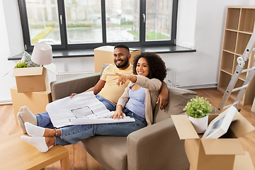 Image showing couple with boxes and blueprint moving to new home