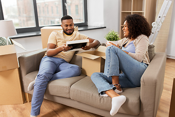 Image showing happy couple with boxes moving to new home