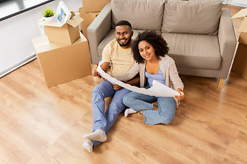 Image showing couple with boxes and blueprint moving to new home