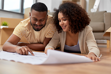 Image showing couple with boxes and blueprint moving to new home