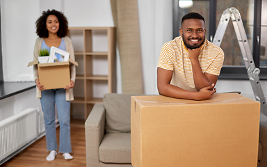 Image showing happy couple with boxes moving to new home