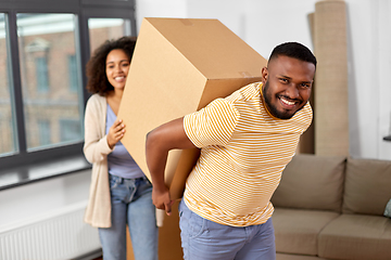 Image showing happy couple with boxes moving to new home