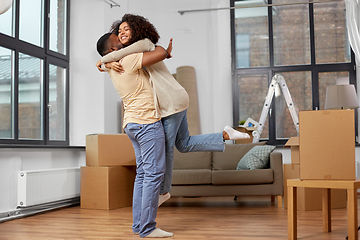 Image showing happy couple with boxes moving to new home