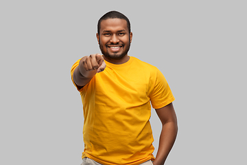 Image showing smiling african american man pointing to camera