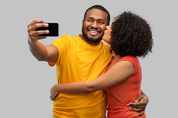 Image showing african american couple taking selfie by cellphone