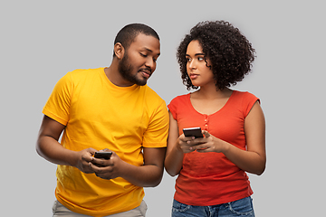 Image showing happy african american couple with smartphones