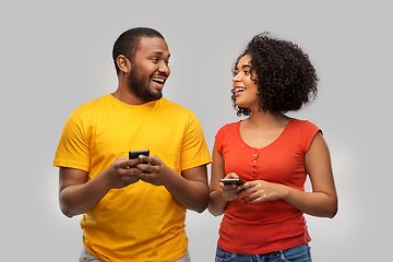 Image showing happy african american couple with smartphones