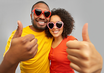 Image showing happy african couple in heart shaped sunglasses