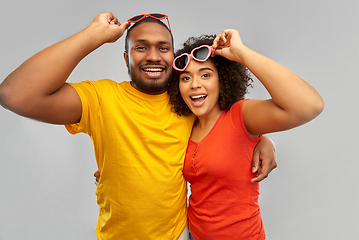 Image showing happy african couple in heart shaped sunglasses