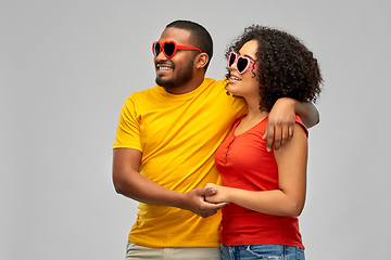 Image showing happy african couple in heart shaped sunglasses