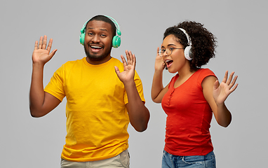 Image showing african american couple with headphones dancing