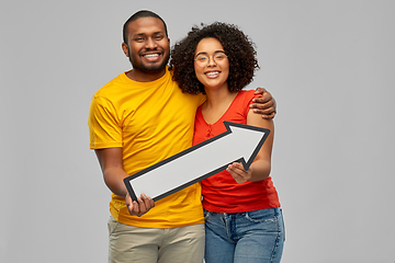 Image showing happy african american couple with arrow to right