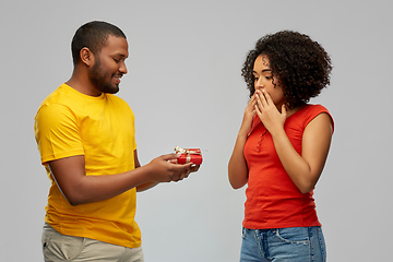 Image showing happy african american couple with red gift box