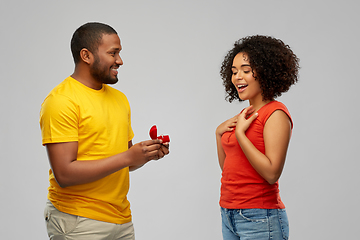 Image showing african american man giving woman engagement ring