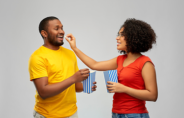 Image showing happy african american couple eating popcorn