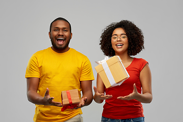 Image showing happy african american couple throwing gift boxes