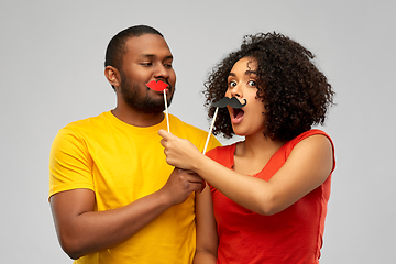 Image showing happy african american couple with party props