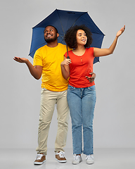 Image showing smiling african american couple with umbrella