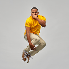 Image showing young african american man jumping in air